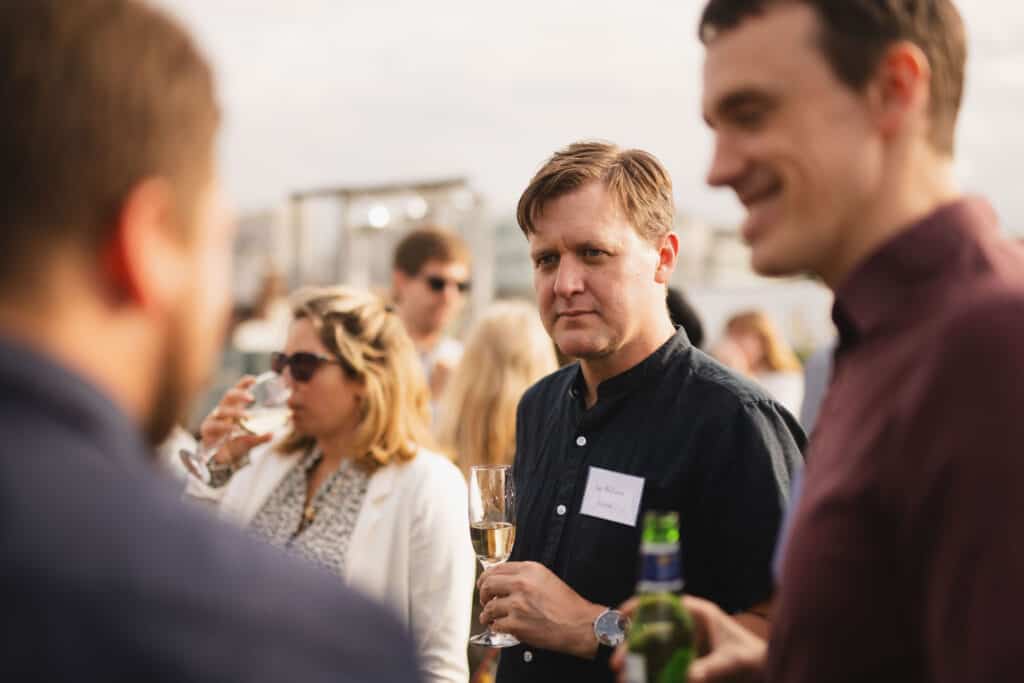 People chatting at the Babel PR UpOntheRoof Party 2023